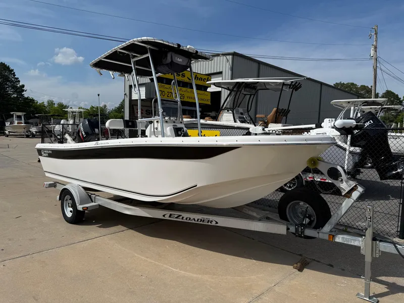 Slide: The Image of 2012 Carolina Skiff 19 Ultra boat on trailer, parked outdoors under clear sky. - 1