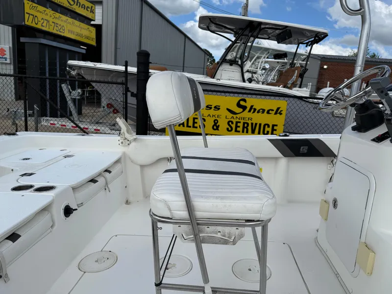 Slide: The Image of 2012 Carolina Skiff 19 Ultra boat interior with white seating and steering console. - 10