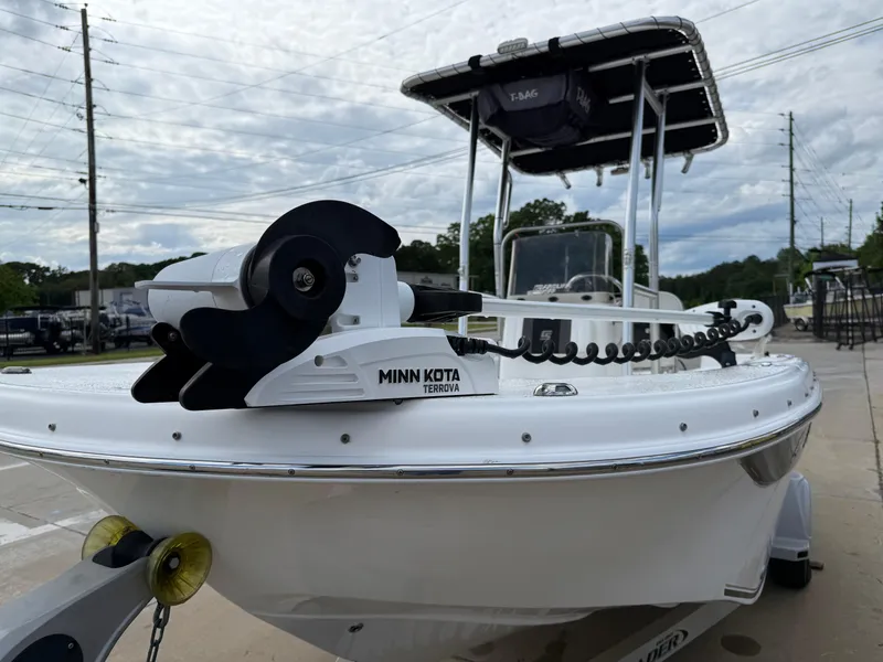 Slide: The Image of 2012 Carolina Skiff 19 Ultra boat with Minn Kota trolling motor, parked on a trailer. - 13