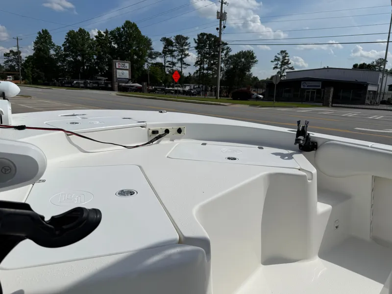 Slide: The Image of 2012 Carolina Skiff 19 Ultra boat interior with white deck and clear sky background. - 16