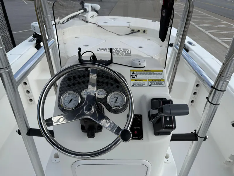 Slide: The Image of 2012 Carolina Skiff 19 Ultra boat dashboard with steering wheel and controls. - 19