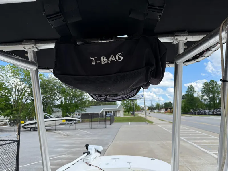 Slide: The Image of 2012 Carolina Skiff 19 Ultra with T-Bag storage under T-top, parked outdoors. - 20