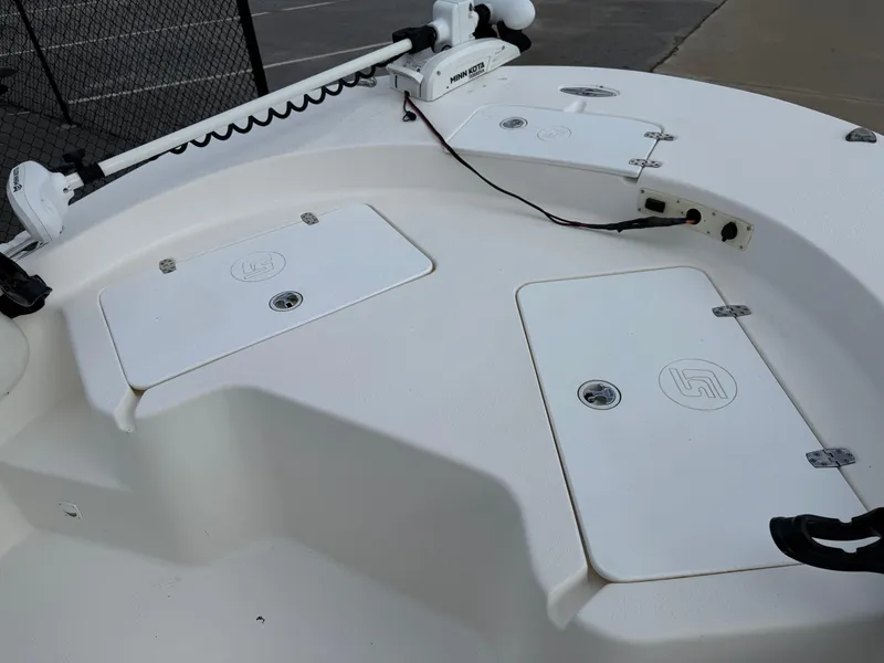 Slide: The Image of 2012 Carolina Skiff 19 Ultra boat deck with storage compartments and trolling motor. - 22