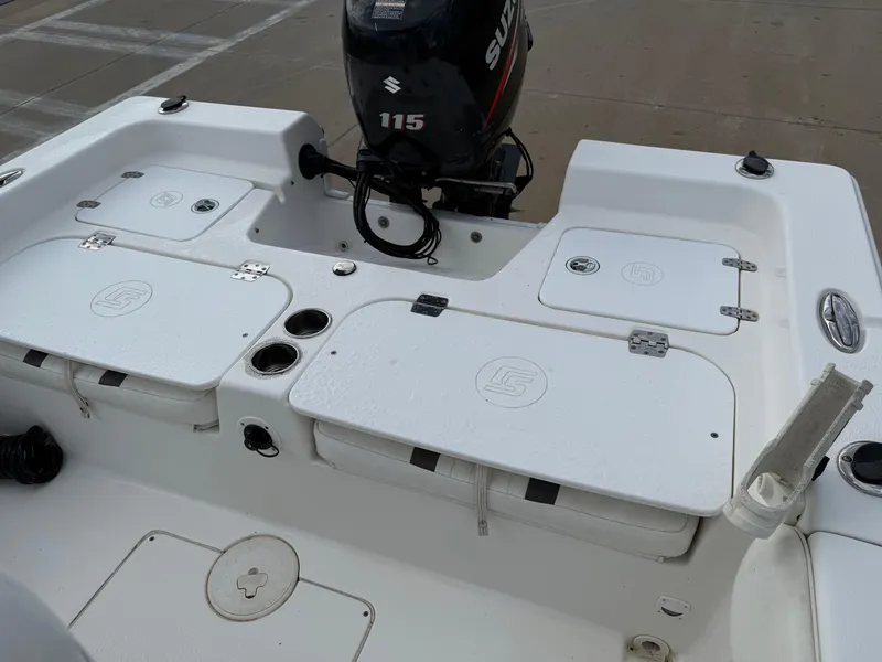 Slide: The Image of 2012 Carolina Skiff 19 Ultra boat with Suzuki 115 outboard motor, featuring storage compartments. - 27