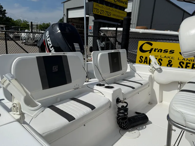Slide: The Image of 2012 Carolina Skiff 19 Ultra boat interior with seating and Suzuki outboard motor. - 28