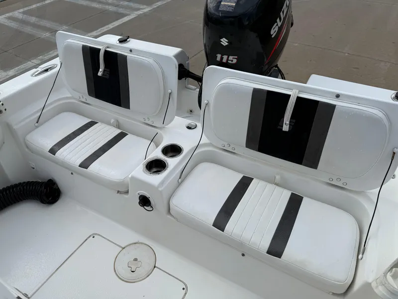 Slide: The Image of 2012 Carolina Skiff 19 Ultra boat interior with dual seats and Suzuki 115 outboard motor. - 29