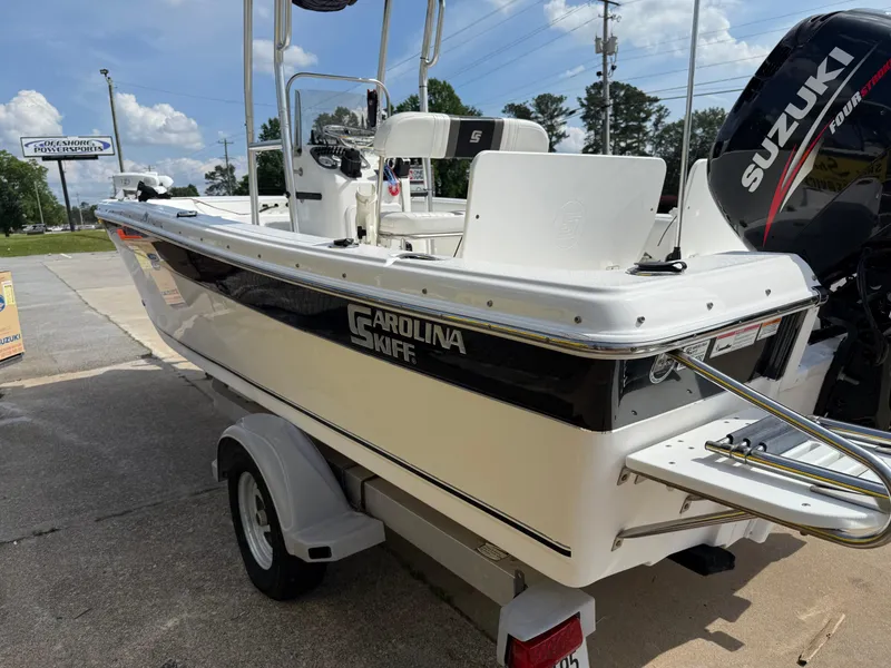 Slide: The Image of 2012 Carolina Skiff 19 Ultra boat on trailer, featuring Suzuki outboard motor. - 3