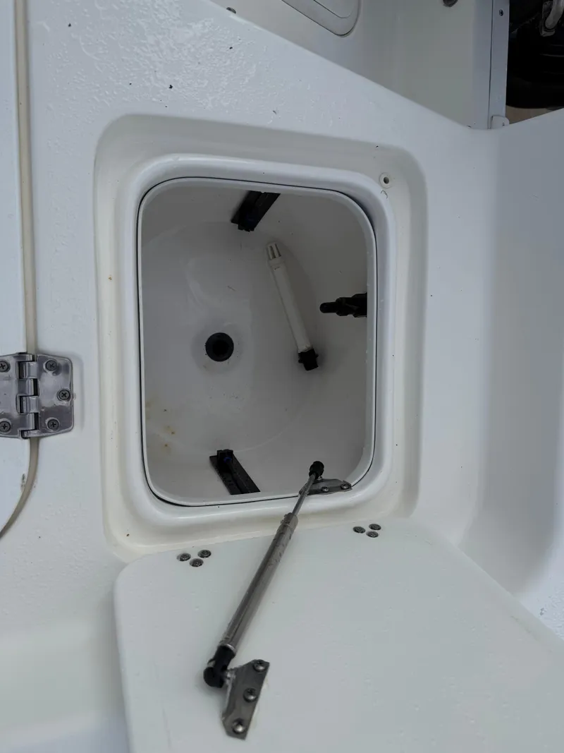 Slide: The Image of 2012 Carolina Skiff 19 Ultra boat storage compartment with open hatch and hydraulic support. - 30