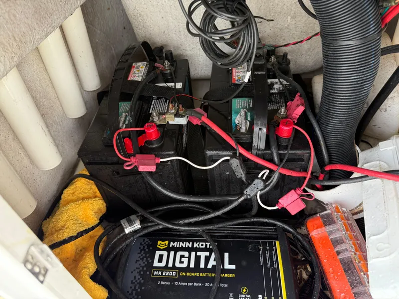 Slide: The Image of Batteries and Minn Kota charger in 2012 Carolina Skiff 19 Ultra boat compartment. - 37