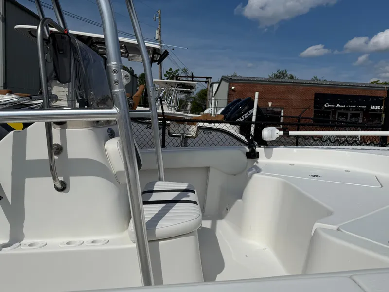 Slide: The Image of 2012 Carolina Skiff 19 Ultra boat interior with seating and railing under a clear sky. - 40