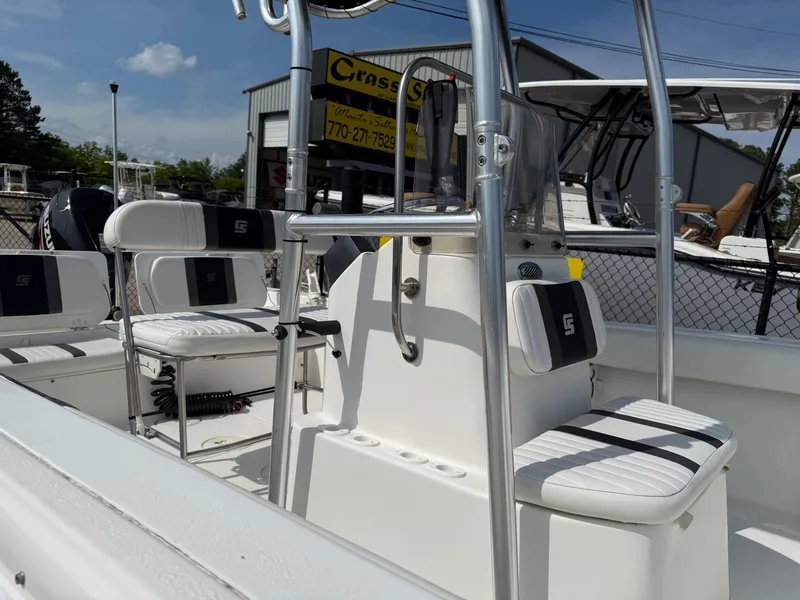 Slide: The Image of 2012 Carolina Skiff 19 Ultra boat interior with seating and console, displayed outdoors. - 41
