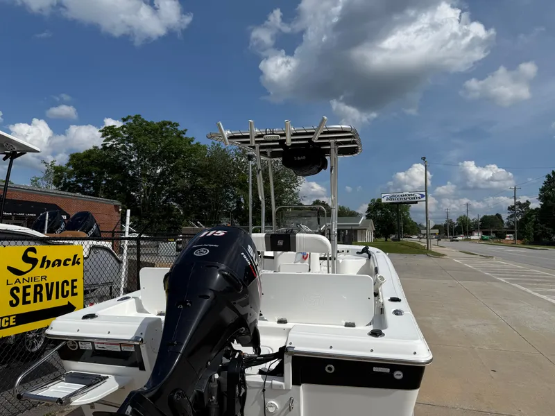 Slide: The Image of 2012 Carolina Skiff 19 Ultra boat with outboard motor, parked on a sunny day. - 42