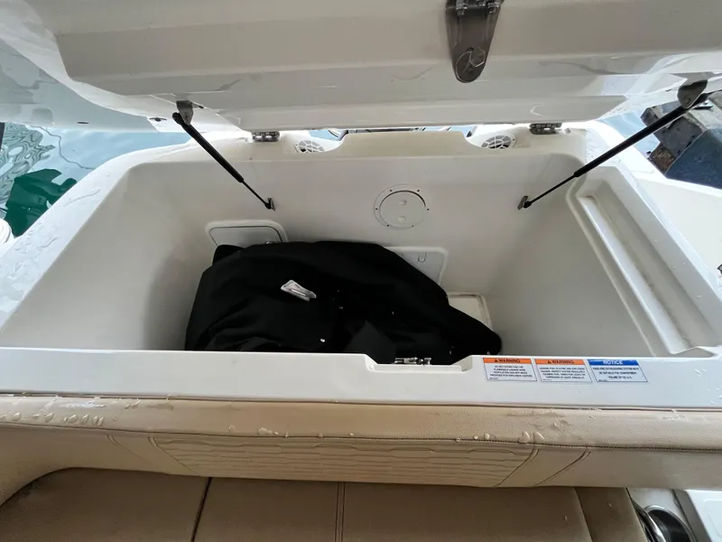 Slide: The Image of Open storage compartment in 2022 Sea Ray SPX 230 OB boat. - 11