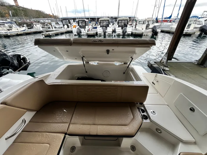 Slide: The Image of 2022 Sea Ray SPX 230 OB boat with open storage, docked at marina. - 12