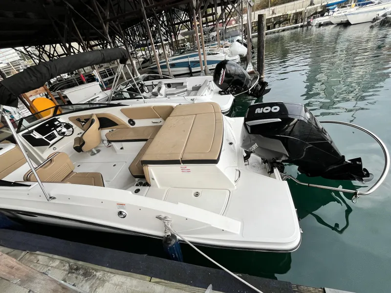 Slide: The Image of 2022 Sea Ray SPX 230 OB boat docked, featuring spacious seating and powerful outboard motor. - 13