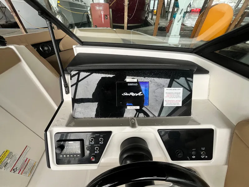 Slide: The Image of 2022 Sea Ray SPX 230 OB dashboard with Simrad display and controls. - 5