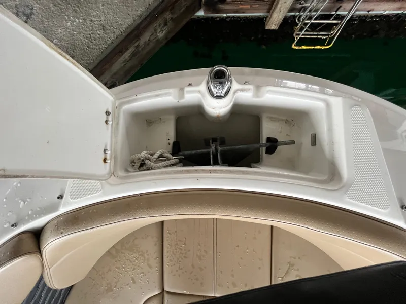 Slide: The Image of 2022 Sea Ray SPX 230 OB boat anchor storage compartment with open hatch. - 6