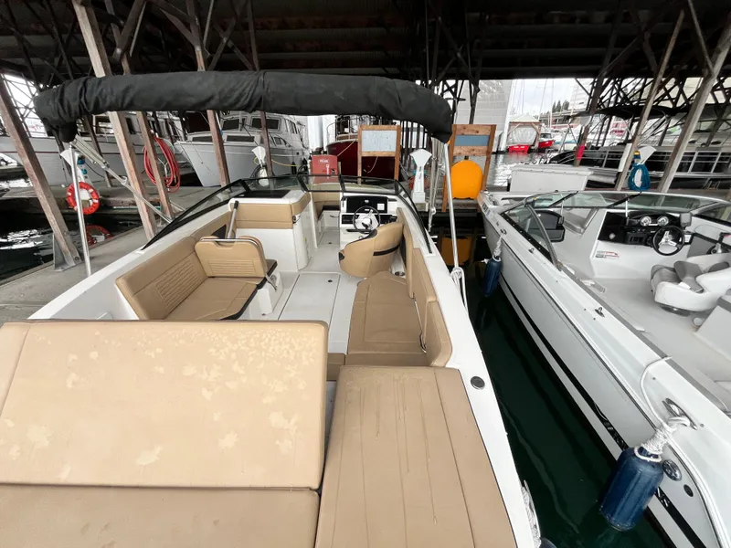 Slide: The Image of 2022 Sea Ray SPX 230 OB boat docked, featuring spacious seating and modern design. - 8