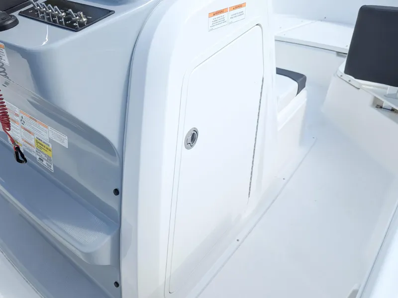 Slide: The Image of 2025 Bayliner Trophy T22CC boat console with storage compartment and control panel. - 13