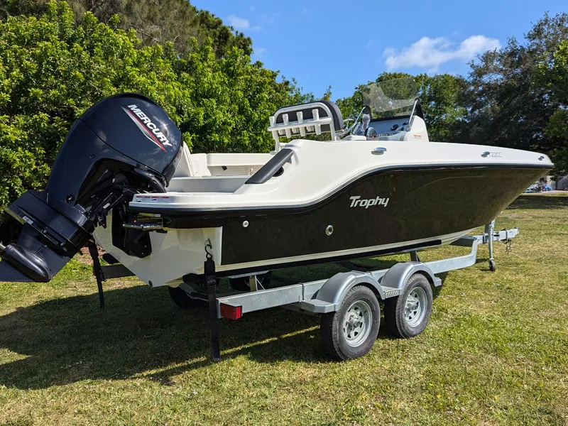 Slide: The Image of 2025 Bayliner Trophy T22CC boat on trailer with Mercury outboard motor. - 2