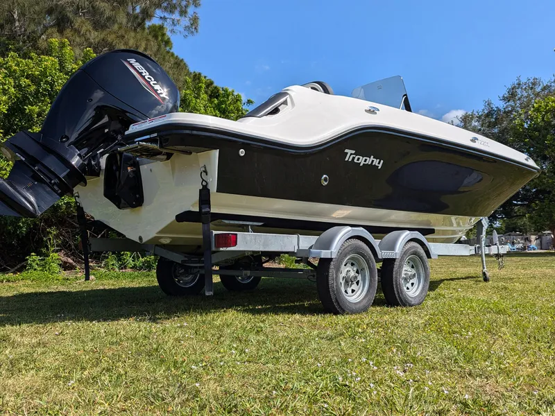 Slide: The Image of 2025 Bayliner Trophy T22CC boat on trailer with Mercury outboard motor. - 3
