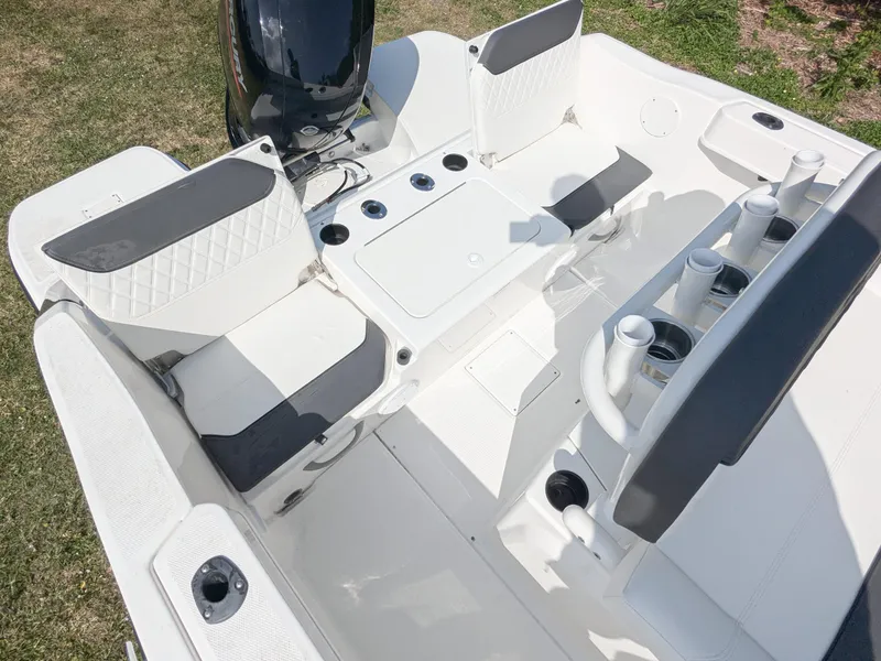 Slide: The Image of 2025 Bayliner Trophy T22CC boat interior with seating and Mercury engine. - 5