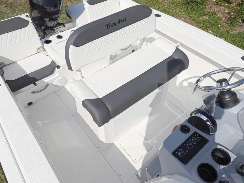 Slide: The Image of 2025 Bayliner Trophy T22CC boat interior with seating and storage compartments. - 6
