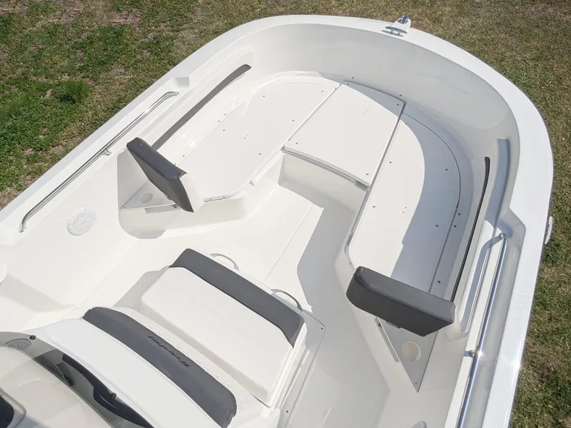 Slide: The Image of 2025 Bayliner Trophy T22CC boat interior with seating and steering console. - 7
