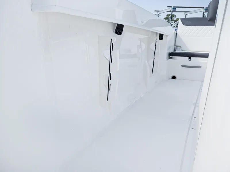 Slide: The Image of 2025 Bayliner Trophy T22CC boat interior with cushioned seating and storage compartments. - 9