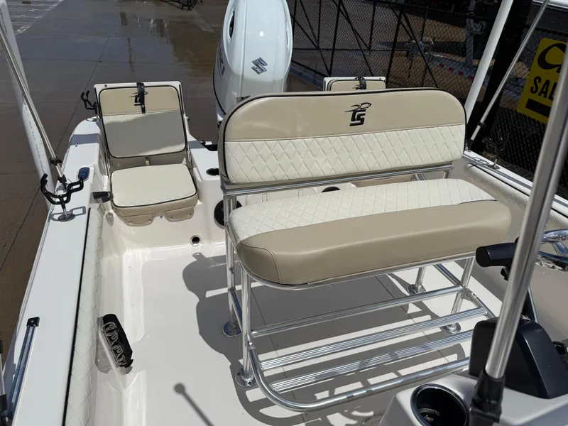 Slide: The Image of 2022 Carolina Skiff 21 LS boat interior with beige seating and Suzuki outboard motor. - 10