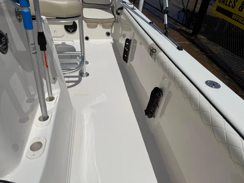 Slide: The Image of 2022 Carolina Skiff 21 LS boat interior with white seating and rod holders. - 11