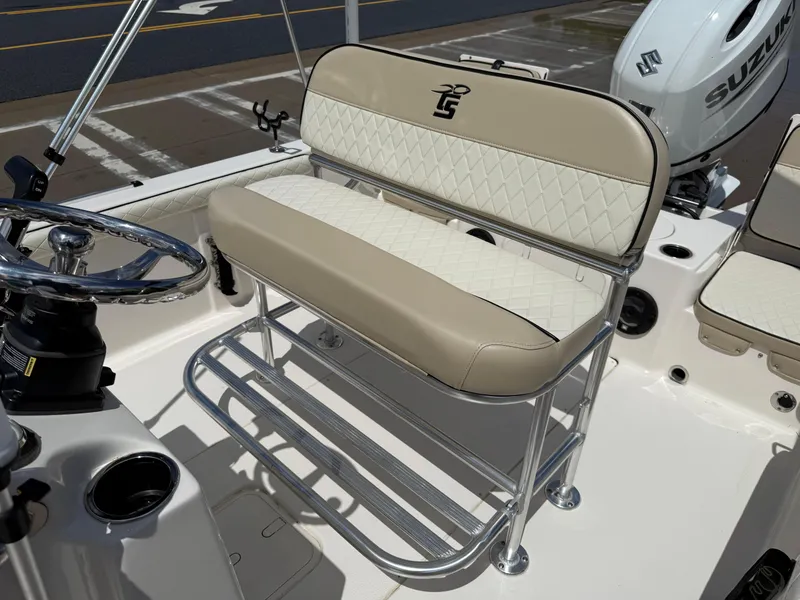 Slide: The Image of 2022 Carolina Skiff 21 LS boat seat with beige and white upholstery, featuring a Suzuki engine. - 12