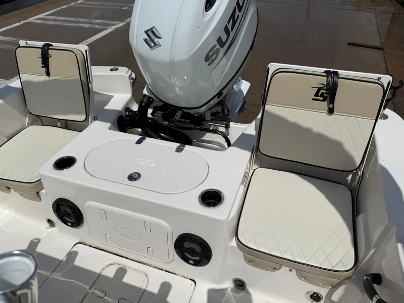 Slide: The Image of 2022 Carolina Skiff 21 LS boat interior with Suzuki outboard motor and cushioned seating. - 13