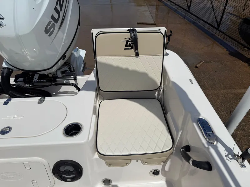 Slide: The Image of 2022 Carolina Skiff 21 LS boat seat with Suzuki engine, featuring diamond-pattern upholstery. - 14