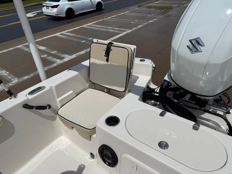 Slide: The Image of 2022 Carolina Skiff 21 LS boat interior with seating and Suzuki outboard motor. - 15