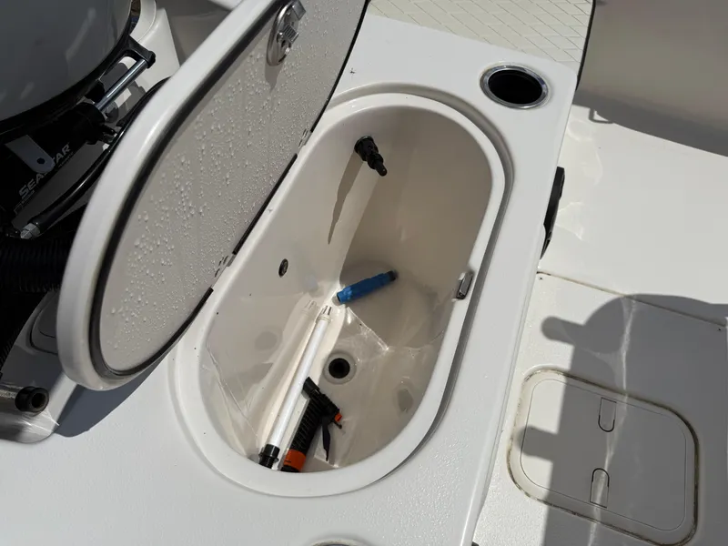 Slide: The Image of Open storage compartment on 2022 Carolina Skiff 21 LS boat with tools inside. - 16