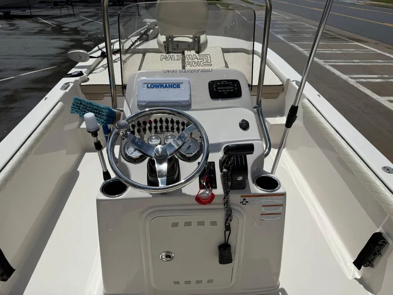 Slide: The Image of 2022 Carolina Skiff 21 LS boat console with steering wheel and navigation equipment. - 18