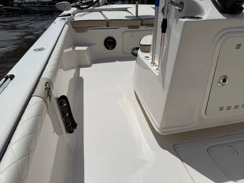 Slide: The Image of 2022 Carolina Skiff 21 LS boat interior with white seating and storage compartments. - 23