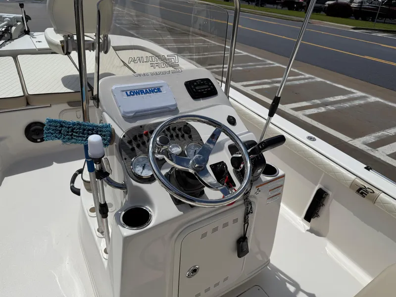 Slide: The Image of 2022 Carolina Skiff 21 LS boat console with steering wheel and controls. - 24
