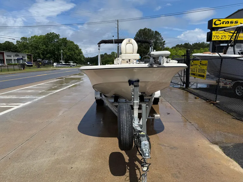 Slide: The Image of 2022 Carolina Skiff 21 LS boat on trailer, parked on wet pavement near dealership. - 3