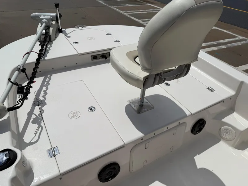 Slide: The Image of 2022 Carolina Skiff 21 LS boat deck with white seating and storage compartments. - 31