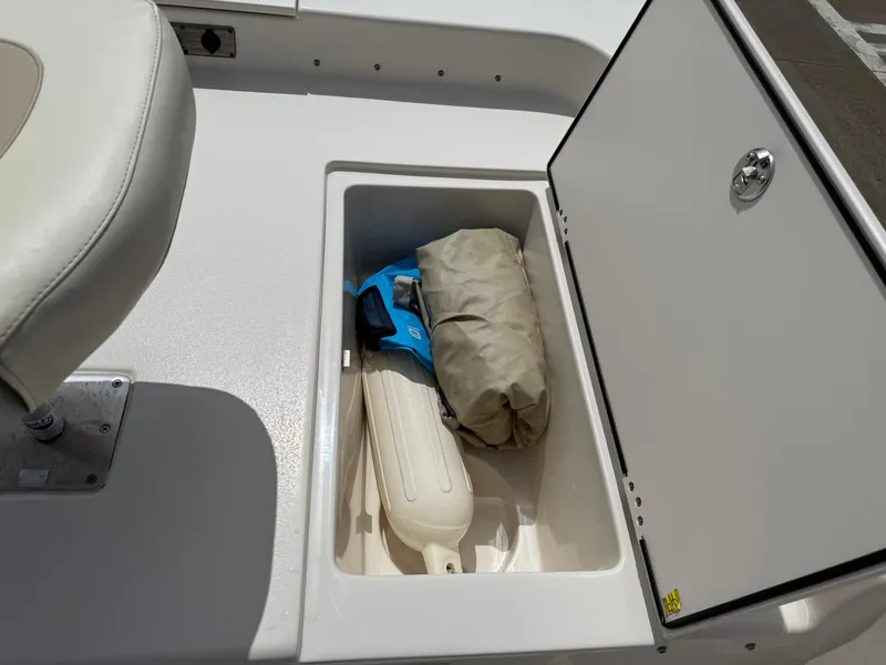 Slide: The Image of Storage compartment in a 2022 Carolina Skiff 21 LS boat with boating accessories. - 33
