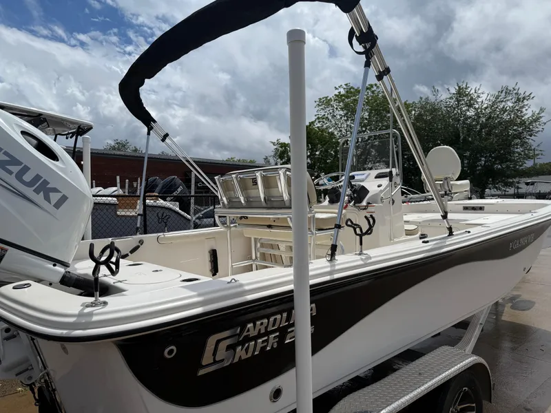 Slide: The Image of 2022 Carolina Skiff 21 LS boat with Suzuki engine, parked outdoors on a trailer. - 38