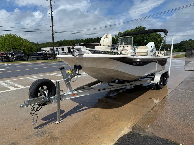Slide: The Image of 2022 Carolina Skiff 21 LS boat on trailer, parked on wet pavement. - 4