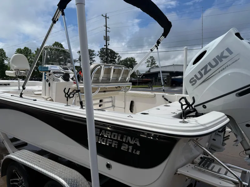 Slide: The Image of 2022 Carolina Skiff 21 LS boat with Suzuki outboard motor on trailer. - 40