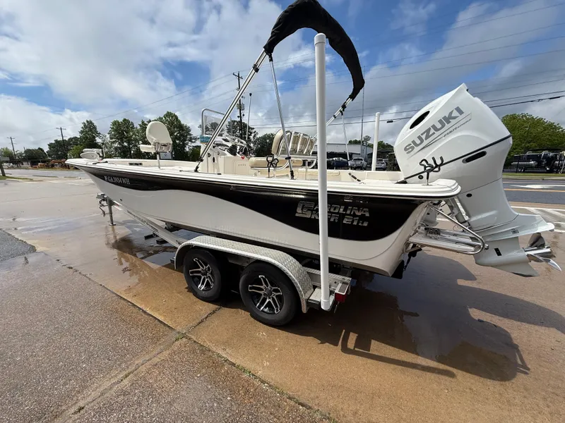 Slide: The Image of 2022 Carolina Skiff 21 LS boat with Suzuki engine on a trailer, parked outdoors. - 41