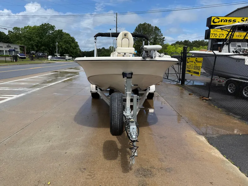 Slide: The Image of 2022 Carolina Skiff 21 LS boat on trailer, parked on wet pavement near a fence. - 45
