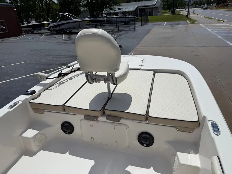 Slide: The Image of 2022 Carolina Skiff 21 LS boat interior with cushioned seating and steering chair. - 7