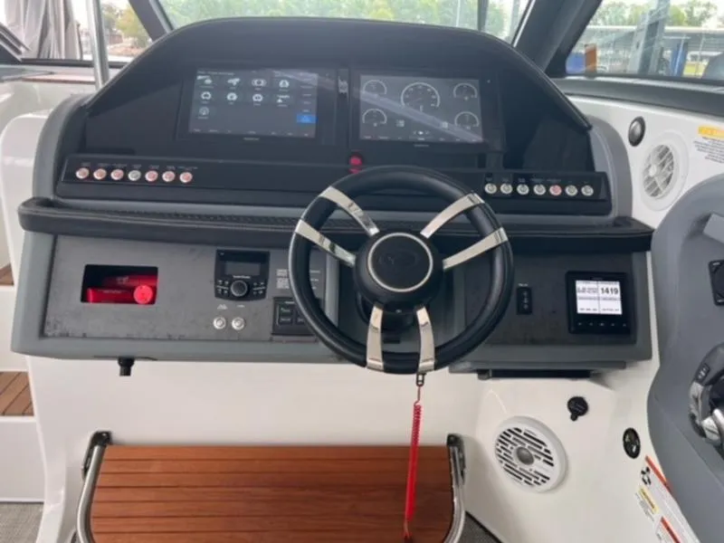 Slide: The Image of Steering console of a 2019 Cobalt A40 boat with modern controls and displays. - 12
