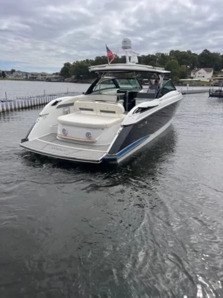 Slide: The Image of 2019 Cobalt A40 boat on a lake, featuring sleek design and American flag. - 13